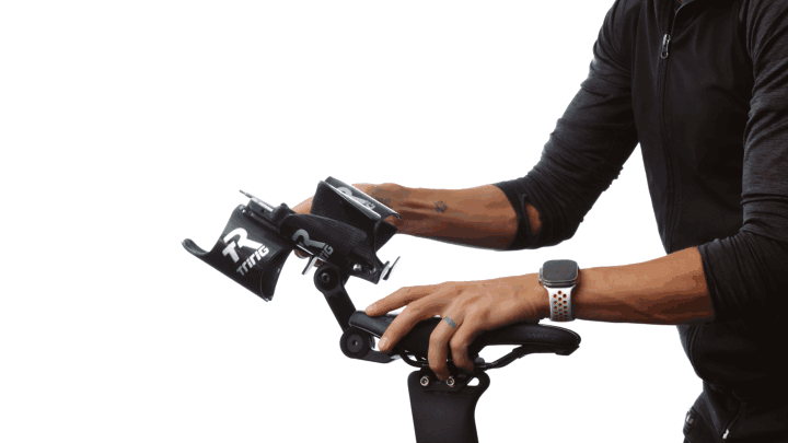 Hands fitting two Kappa cages to the Beta System behind the saddle